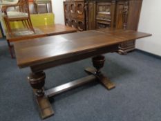 A 20th century oak refectory dining table together with a set of six ladder back chairs.