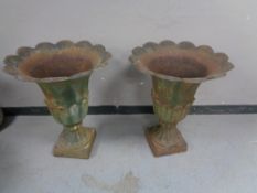 A pair of cast iron fluted garden urns