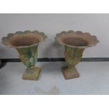 A pair of cast iron fluted garden urns