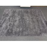 A contemporary grey shaggy pile rug.