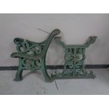 A pair of cast iron garden bench and table ends
