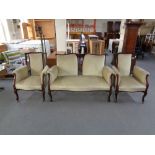 A late 19th century inlaid mahogany three piece lounge suite upholstered in a green dralon.