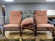 A late twentieth century pair of stained beech armchairs with footstools CONDITION