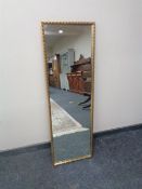 A gilt framed hall mirror together with a framed tapestry.