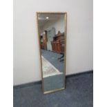 A gilt framed hall mirror together with a framed tapestry.