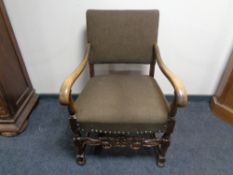 A carved 20th century scroll armchair.