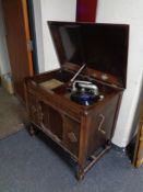 An early 20th century Gilbert gramophone in oak cabinet.