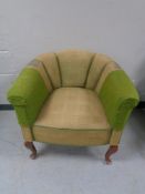 An early 20th century tub chair on Queen Anne legs.