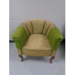 An early 20th century tub chair on Queen Anne legs.