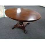 An early 20th century mahogany oval pedestal coffee table.