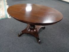 An early 20th century mahogany oval pedestal coffee table.