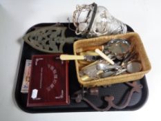 A tray containing cut glass hanging light fitting, miscellaneous table cutlery, metal trivet,