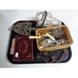 A tray containing cut glass hanging light fitting, miscellaneous table cutlery, metal trivet,