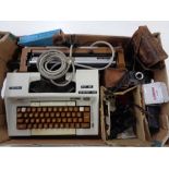 A box containing Smith Corona typewriter, assorted cameras, View master with reels.
