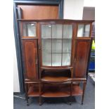 A late Victorian inlaid mahogany display cabinet with undershelf on raised legs