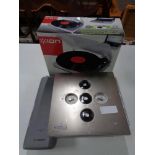A boxed Ion turntable together with a Bosch bike battery and a floor safe.