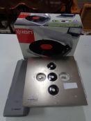 A boxed Ion turntable together with a Bosch bike battery and a floor safe.