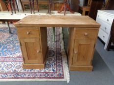 A pine twin pedestal desk