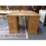 A pine twin pedestal desk