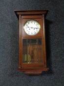 An early 20th century oak cased wall clock with silvered dial.