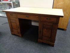 An early 20th century oak twin pedestal desk.