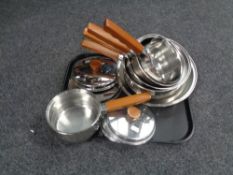 A set of Prestige copper based graduated saucepans with lids together with a box containing linens.