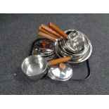 A set of Prestige copper based graduated saucepans with lids together with a box containing linens.