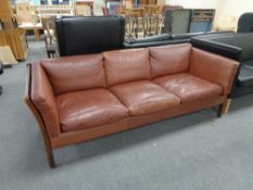 A twentieth century beech framed Stouby leather three seater settee