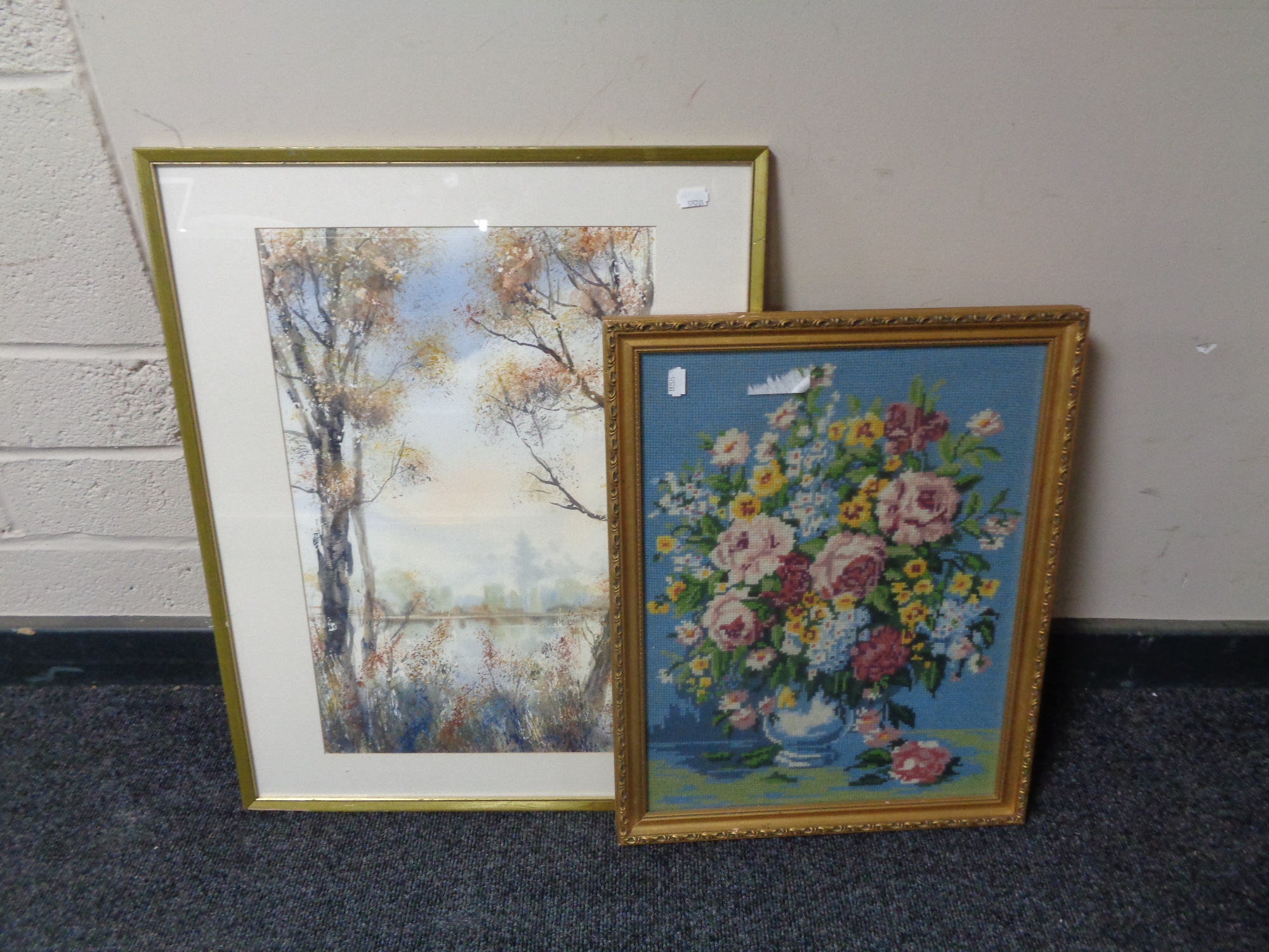 A gilt framed tapestry still life together with a further gilt framed watercolour - Trees with lake