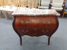 A French Bombe two drawer chest with brass handles and mounts with marble top,