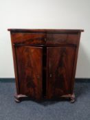 A late 19th century mahogany serpentine fronted double door cabinet, fitted a drawer.