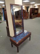 A two drawer tiled topped side table with matching wall mirror