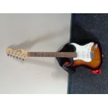 A Squier Strat by Fender electric guitar in carry bag.