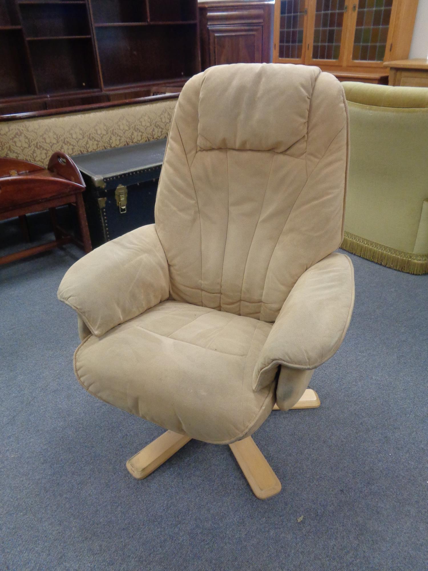 A swivel relaxer chair in suede style fabric