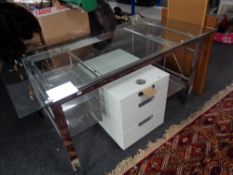 A contemporary glass topped metal based twin pedestal desk