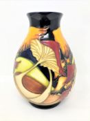 A modern Moorcroft baluster vase decorated with mushrooms on blue ground, height 19cm.
