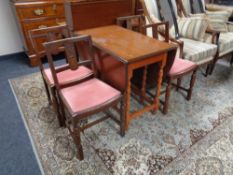 An oak barley twist gateleg table together with four chairs