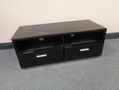 A contemporary black gloss entertainment stand fitted with two drawers