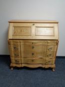 A continental oak serpentine fronted bureau.