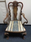 A 19th century Queen Anne style armchair.
