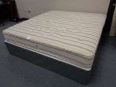 A 6' bed base with sprung mattress (no maker's label)