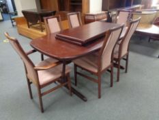 A twentieth century Mobler twin pedestal extending dining table with two leaves and a set of six