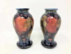 A pair of Moorcroft Pomegranate pattern baluster vases, height 10.5cm.