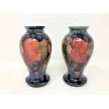 A pair of Moorcroft Pomegranate pattern baluster vases, height 10.5cm.