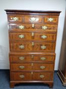 A George II provincial oak and burr walnut nine drawer chest on chest with brass drop handles and