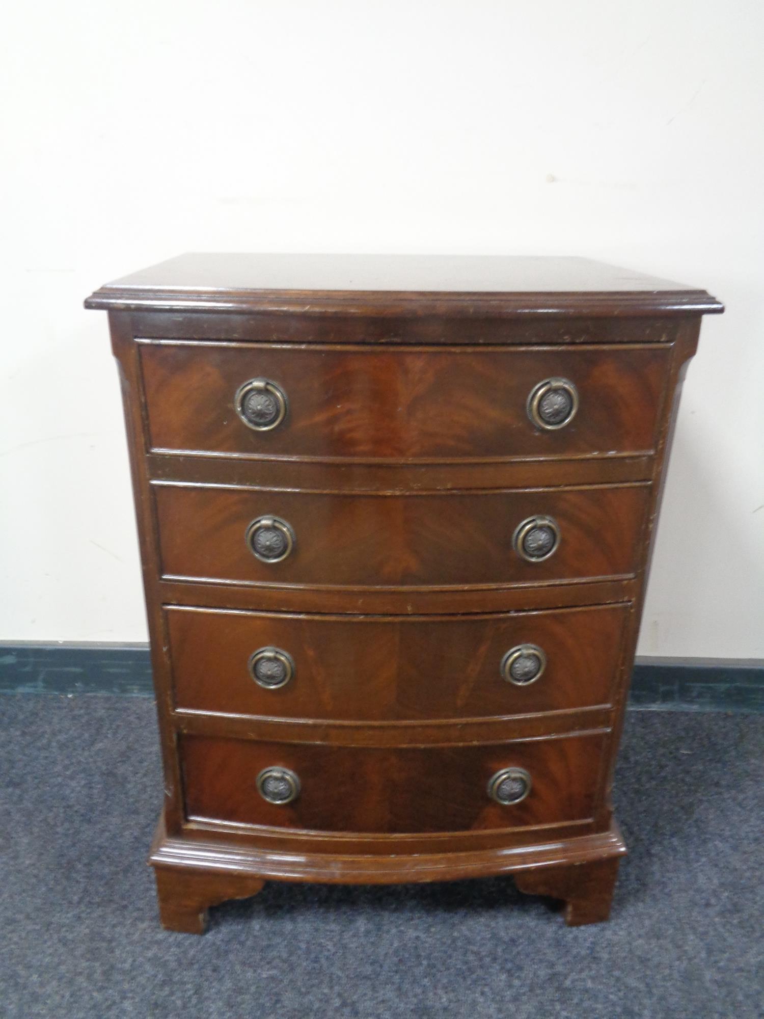 A mahogany Georgian style bow fronted four drawer chest.