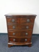 A mahogany Georgian style bow fronted four drawer chest.