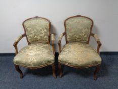 A pair of 20th century carved beech framed salon armchairs upholstered in a green and gold brocade