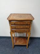 A French marquetry inlaid occasional table fitted three drawers with undershelf