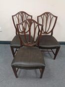 A set of five mahogany shield backed dining chairs